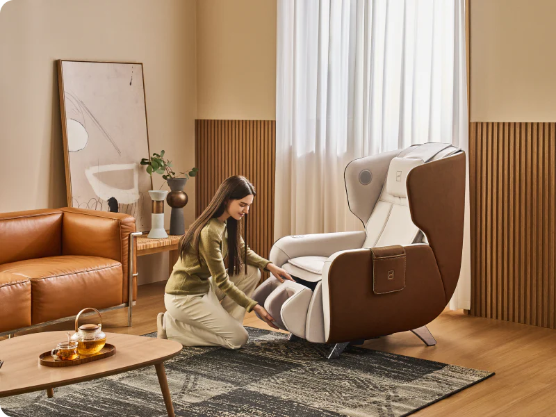 Woman adjusting a Rivio modern massage chair in a stylish living room.